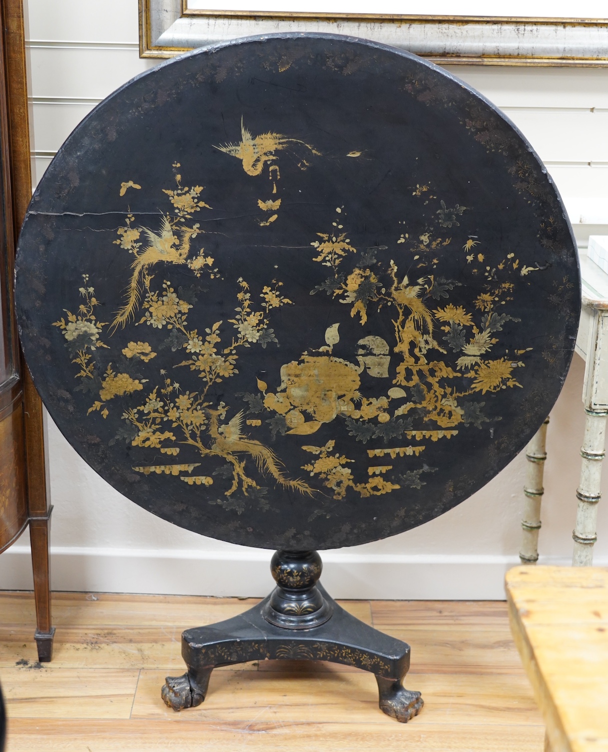 A Chinese export lacquer circular tilt top tea table, diameter 91cm, height 70cm. Condition